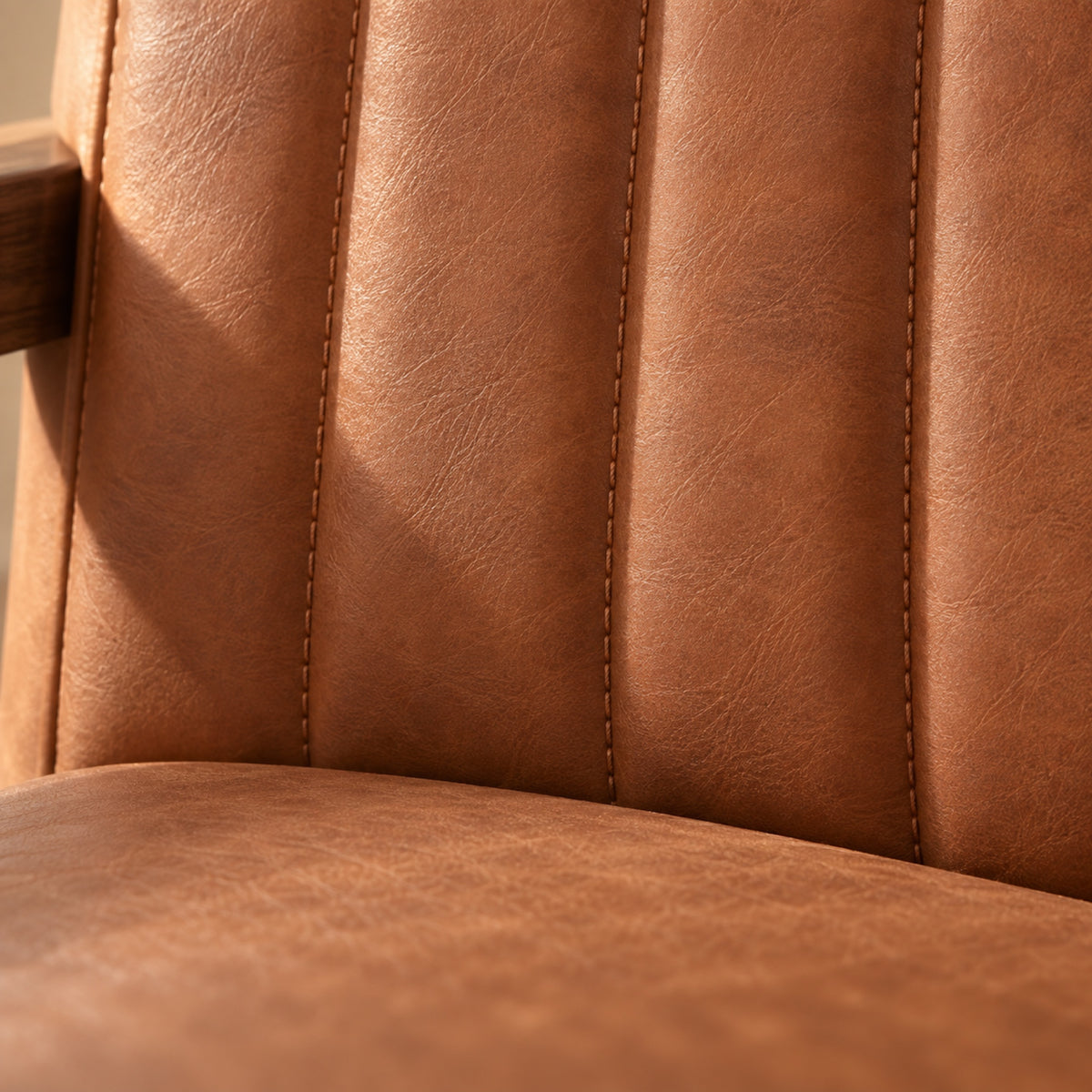 Chaise à bascule rétro en similicuir cognac, bois foncé, gros plan sur la matière