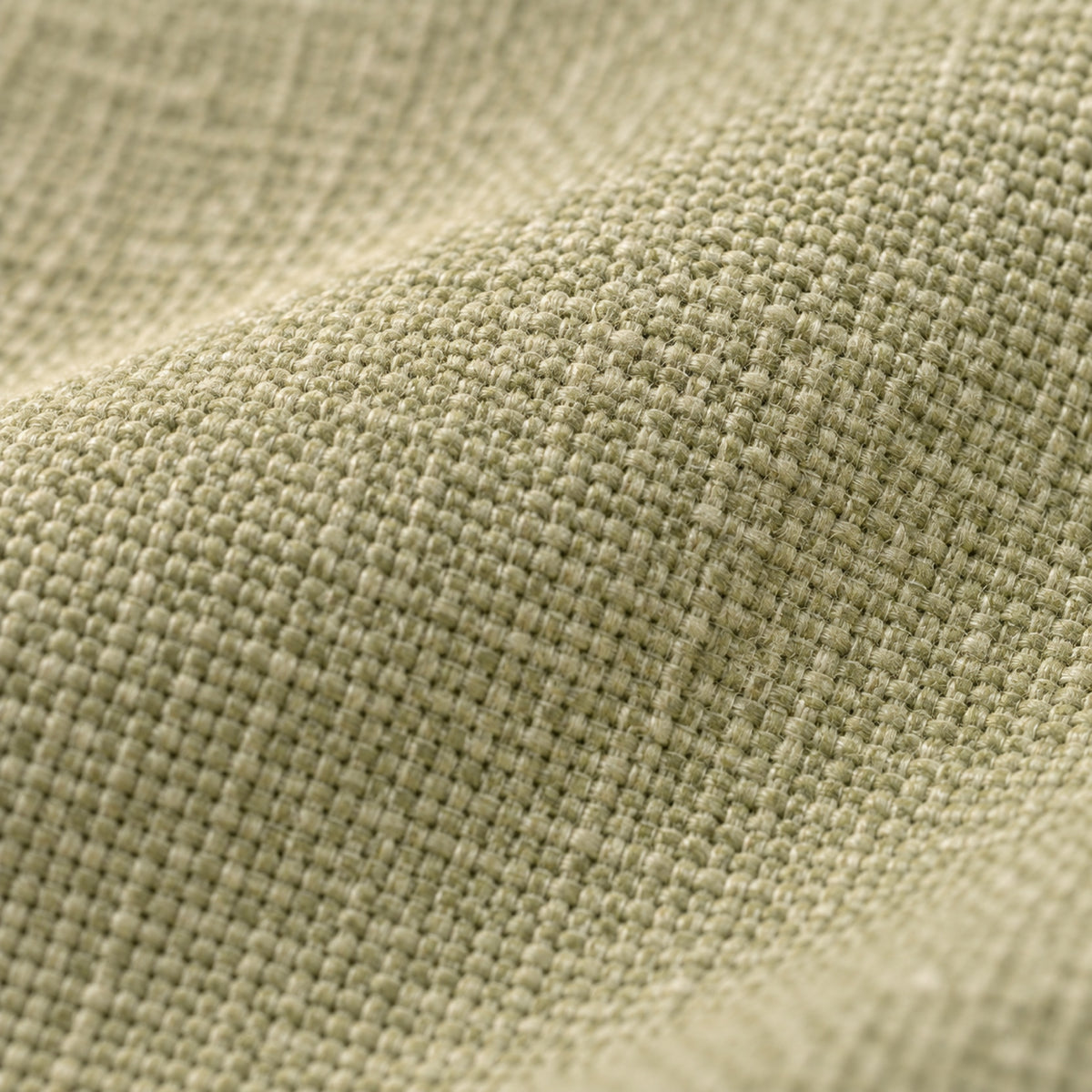Coussin de sol rond épais aspect lin, déhoussable, gros plan sur la matière, coloris Vert amande